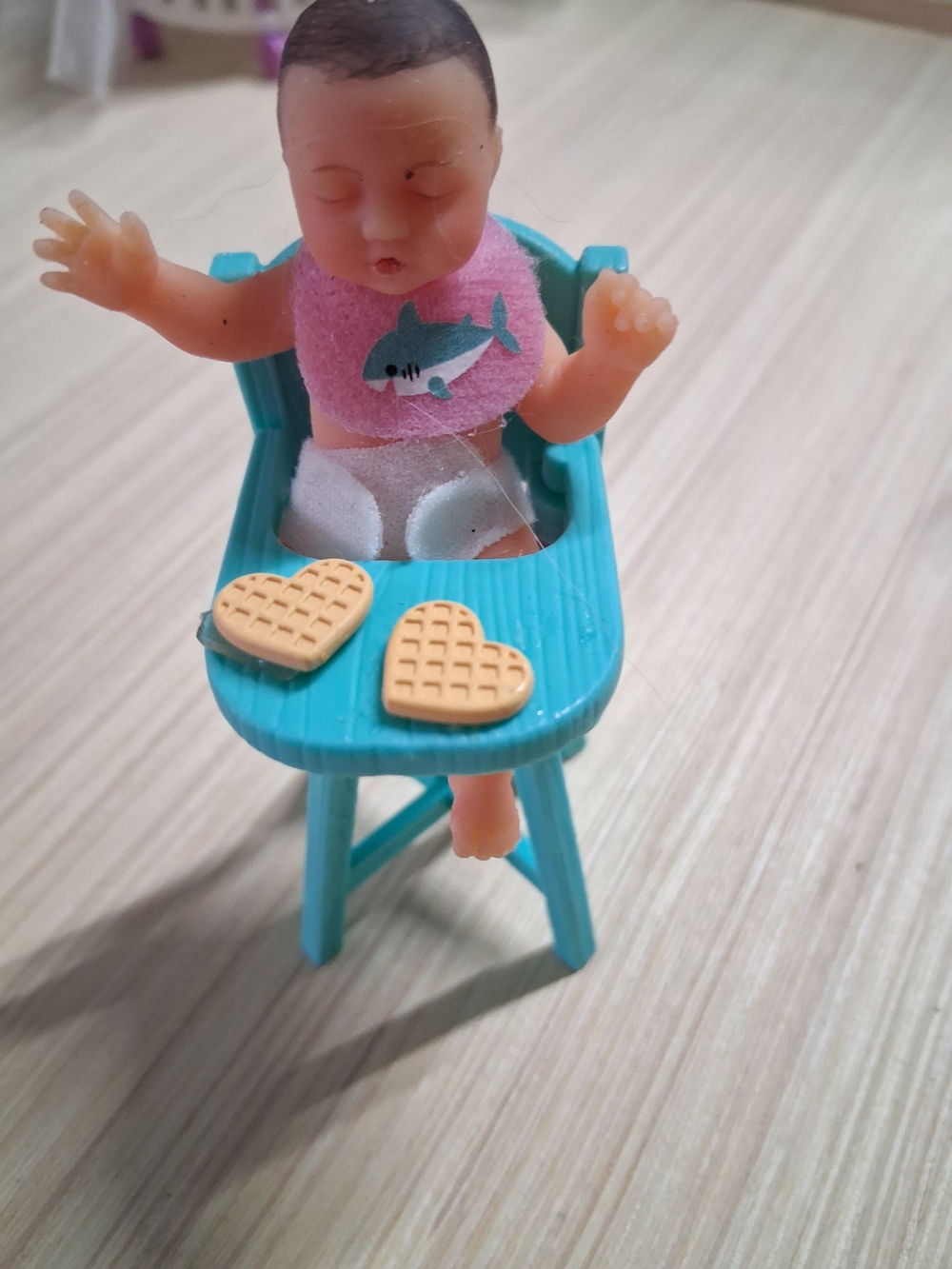 Toy Baby in Teal High Chair with Pink Bib and Heart Waffles